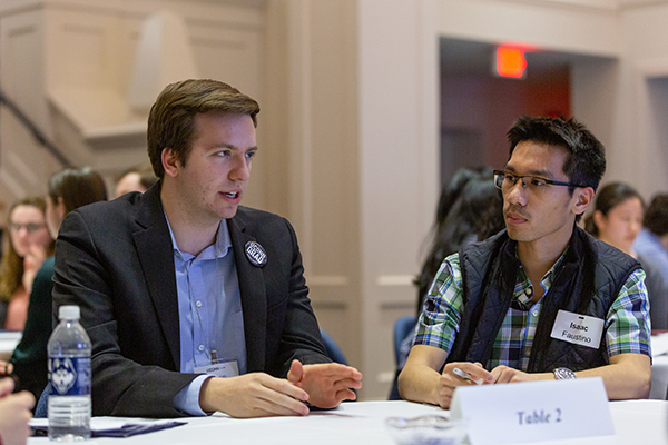 Alumnus speaks with students at a career event